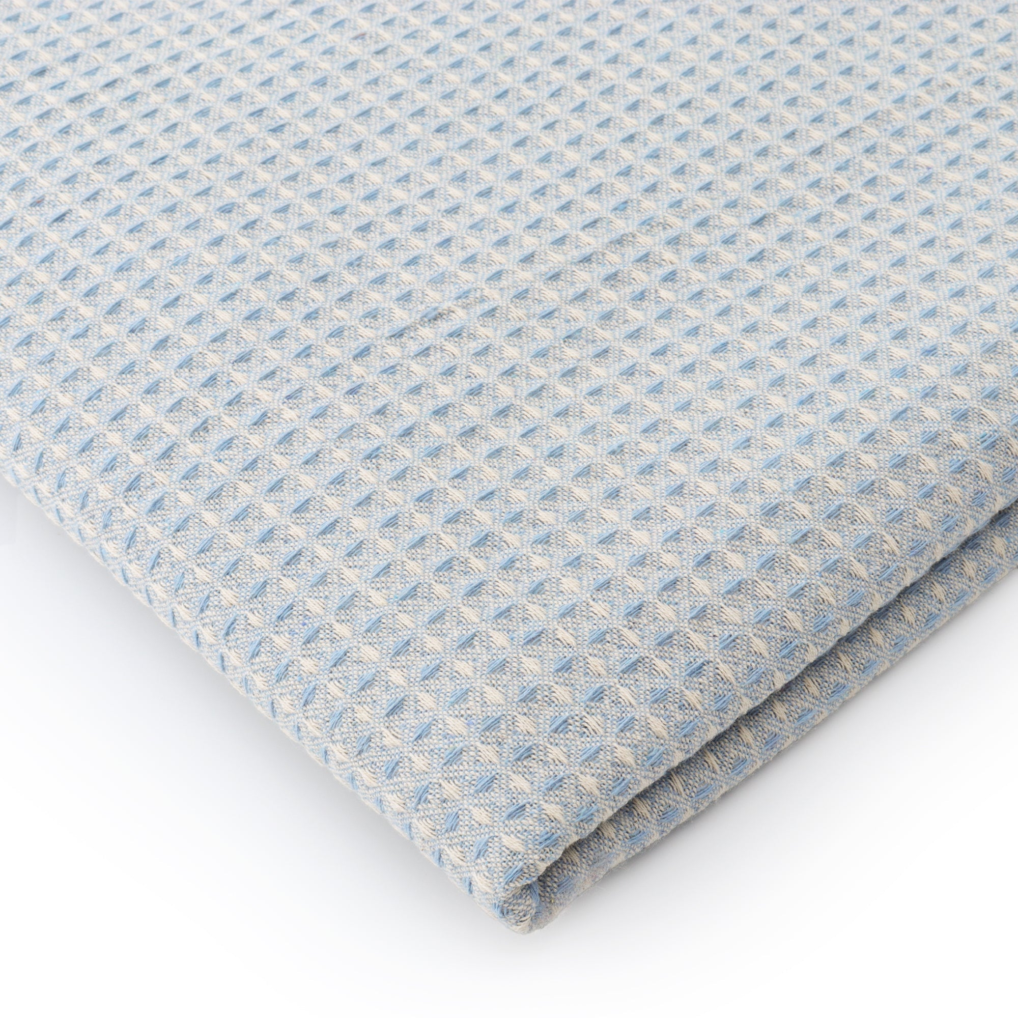 Powder blue waffle texture dining table cover in a modern dining setup