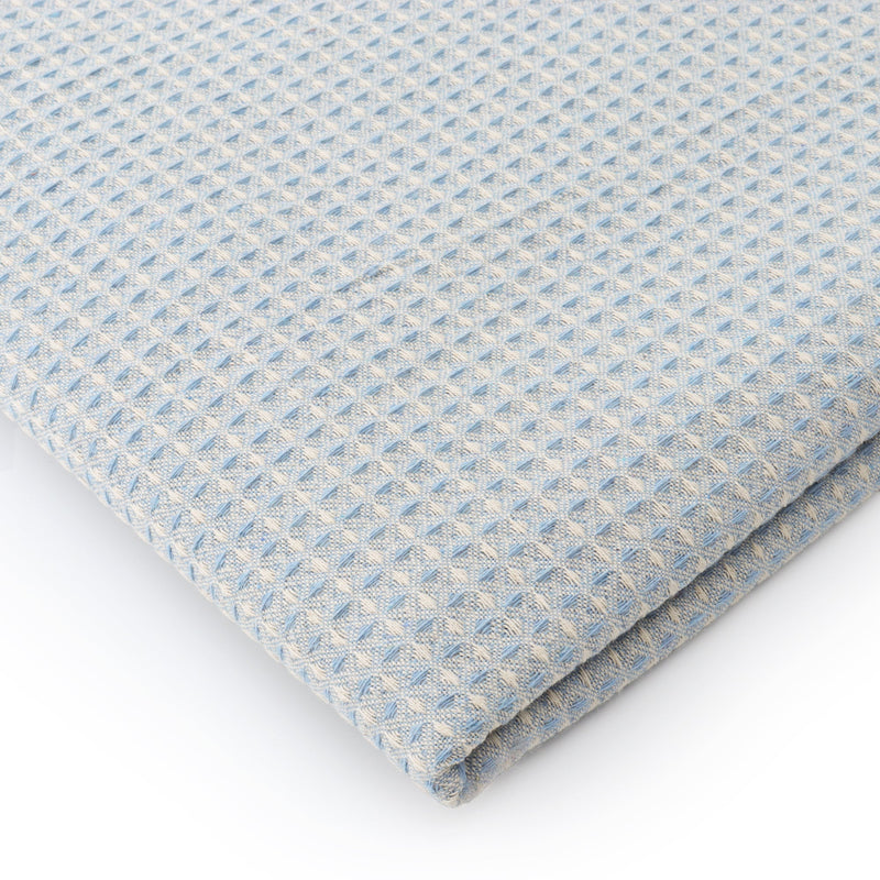 Powder blue waffle texture dining table cover in a modern dining setup