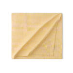 Soft yellow waffle weave dining table cover for elegant homes